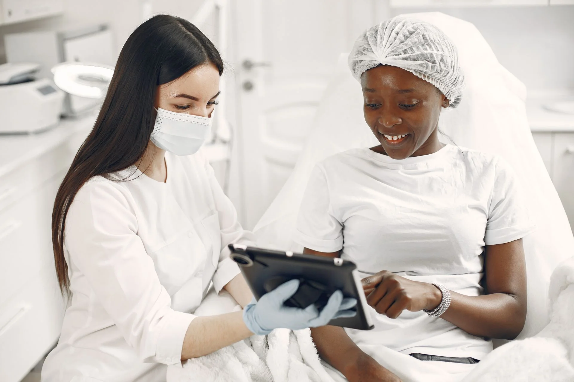 NEODERM specialist and client reviewing digital skin mapping analysis on a tablet